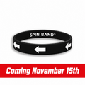 A black silicone wristband with white printed text reading 'SPIN BAND' and three white arrow icons pointing left, shown on a plain white background.