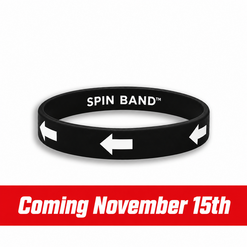 A black silicone wristband with white printed text reading 'SPIN BAND' and three white arrow icons pointing left, shown on a plain white background.